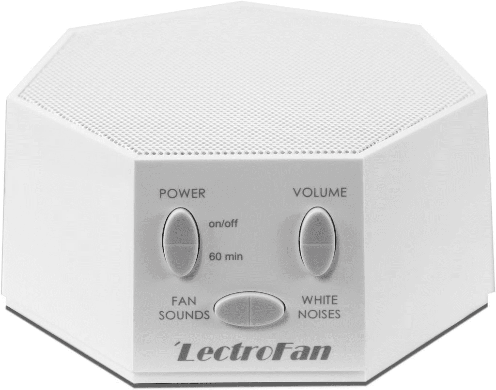 LectroFan Classic compact white noise machine on a desk, designed to block out distractions with soothing sound options.